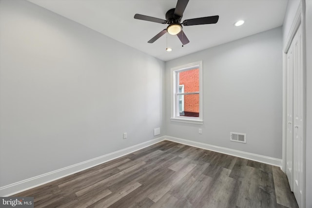 unfurnished bedroom featuring ceiling fan, dark hardwood / wood-style floors, and a closet