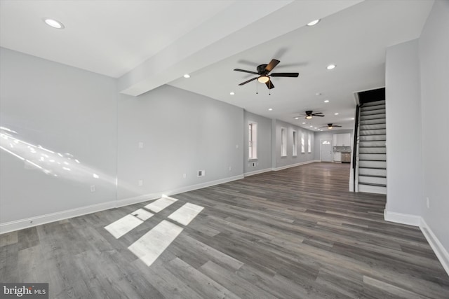 unfurnished living room with dark hardwood / wood-style flooring and ceiling fan