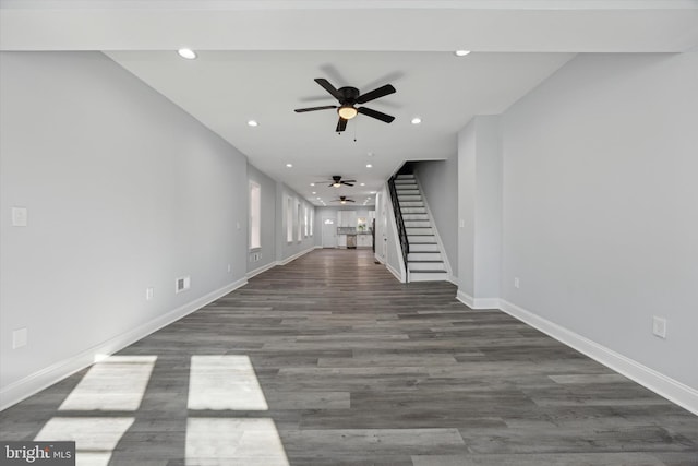 unfurnished living room with ceiling fan and dark hardwood / wood-style flooring