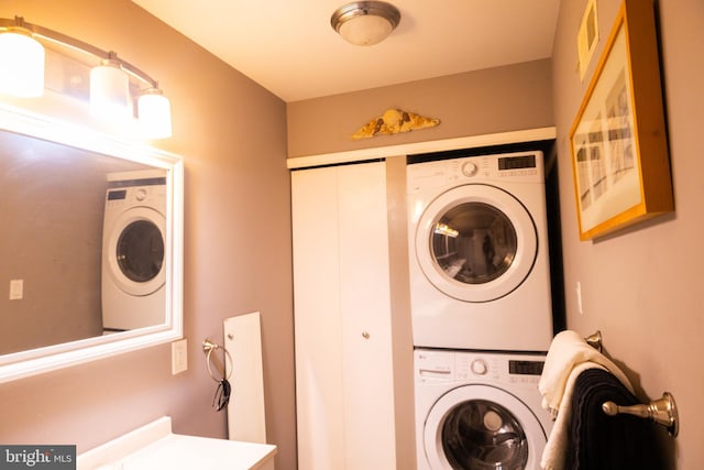 clothes washing area with stacked washer and dryer