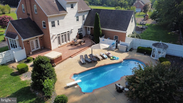 view of pool featuring a diving board, french doors, and a patio