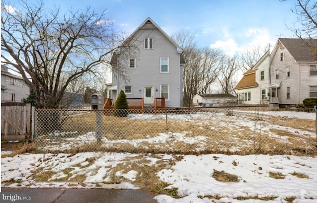 view of snow covered rear of property