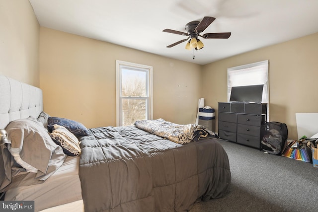 bedroom featuring ceiling fan and carpet