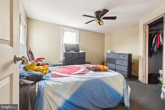 carpeted bedroom with ceiling fan and a closet