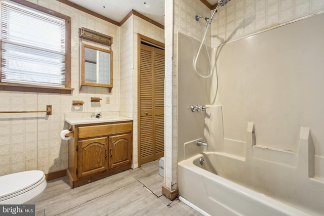 full bathroom with toilet, vanity, crown molding, and bathing tub / shower combination