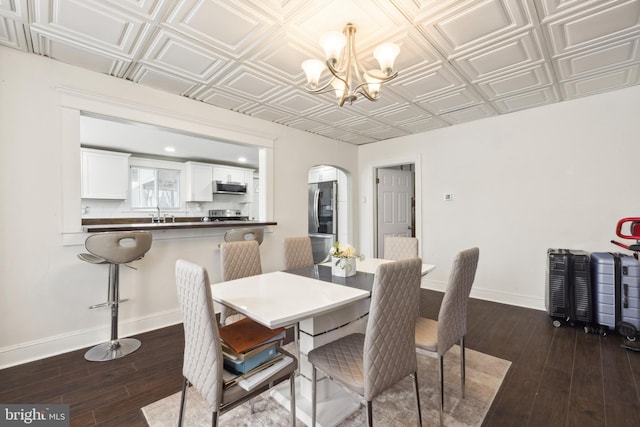 dining room featuring an inviting chandelier and dark hardwood / wood-style flooring