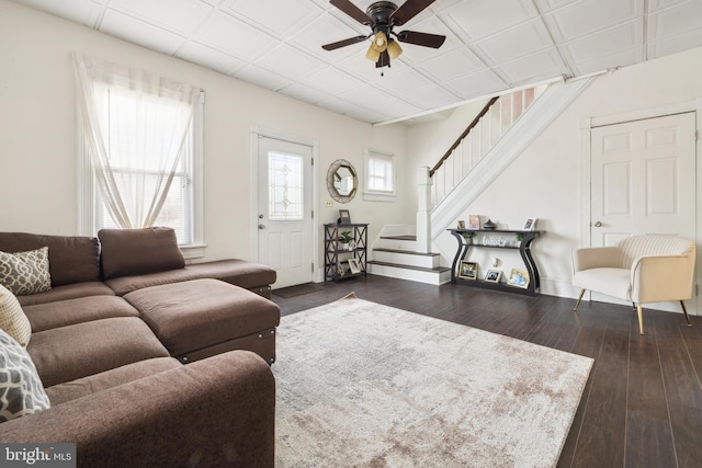 living room with ceiling fan and dark wood-type flooring