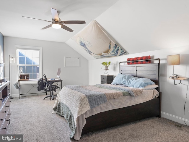 carpeted bedroom with ceiling fan and vaulted ceiling