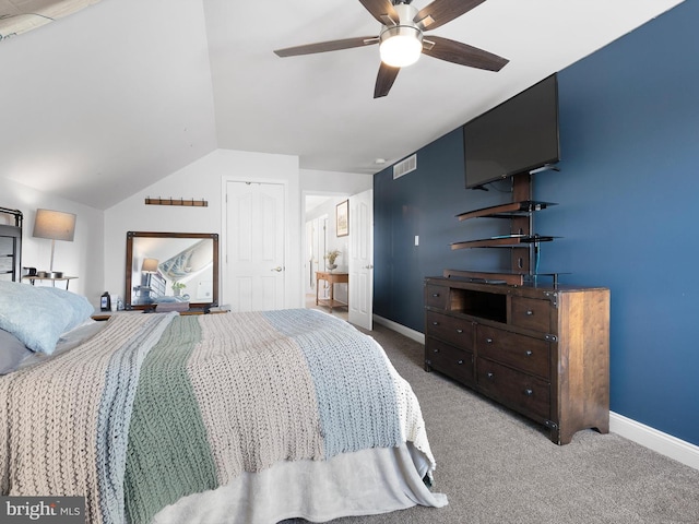 bedroom featuring lofted ceiling, carpet flooring, a closet, and ceiling fan