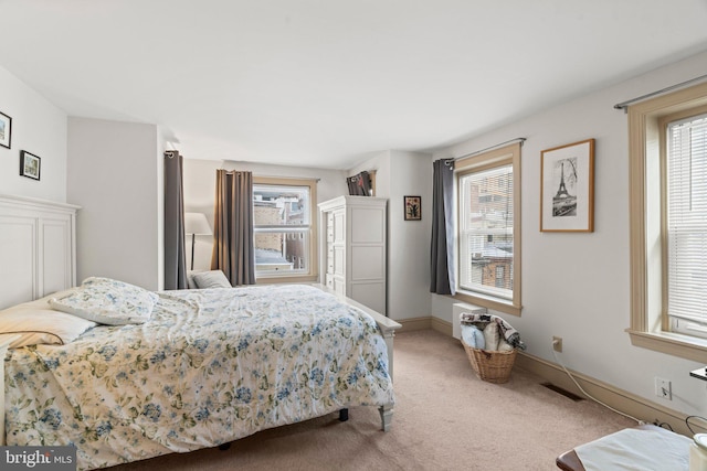 carpeted bedroom with multiple windows