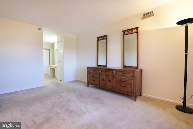 3310 N Leisure World Blvd Unit 6-612, Silver Spring, MD 20906 - unfurnished bedroom with connected bathroom and light carpet