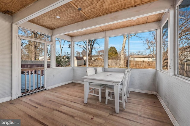 unfurnished sunroom with wooden ceiling and a wealth of natural light