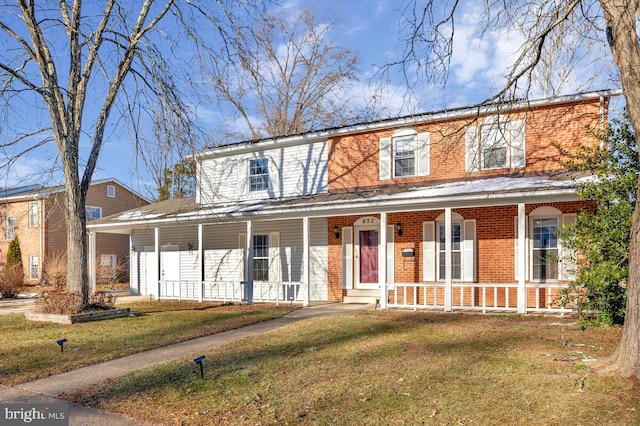 view of front of house with a porch and a front lawn