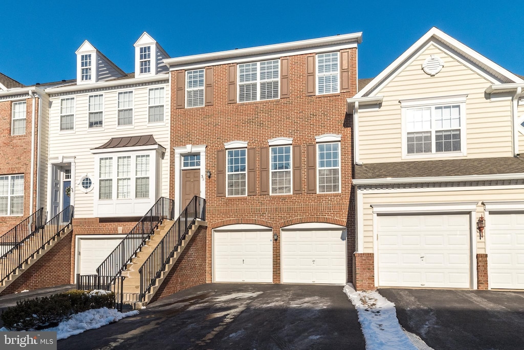 townhome / multi-family property featuring a garage