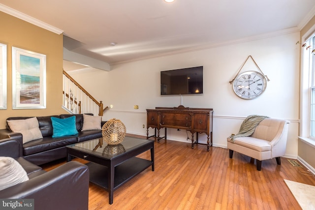 living room featuring crown molding and wood-type flooring