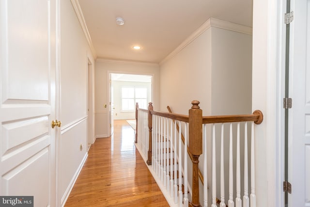 hallway featuring ornamental molding and light wood-type flooring