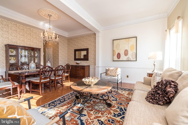 living room featuring crown molding, an inviting chandelier, and hardwood / wood-style floors