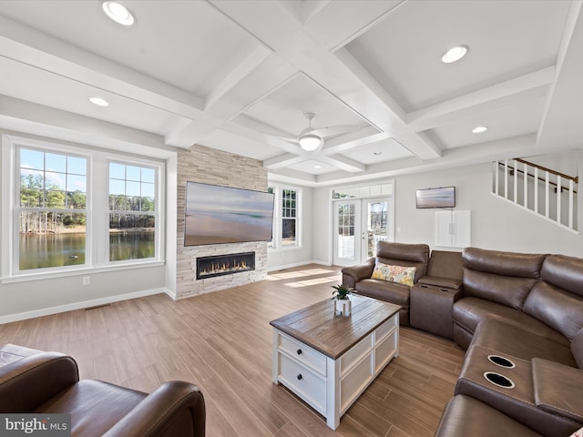 living room featuring coffered ceiling, wood finished floors, and baseboards