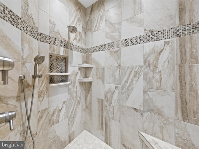 full bath with tiled shower