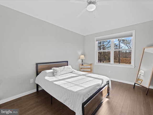 bedroom with wood finished floors, a ceiling fan, and baseboards