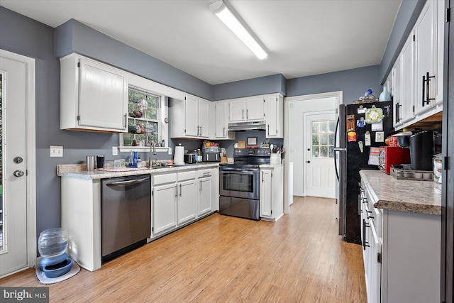 kitchen featuring white cabinetry, sink, a wealth of natural light, and appliances with stainless steel finishes