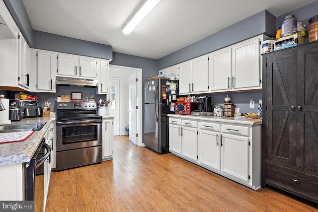 kitchen with appliances with stainless steel finishes, sink, light hardwood / wood-style flooring, and white cabinets