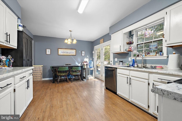 kitchen featuring decorative light fixtures, white cabinetry, sink, stainless steel dishwasher, and light hardwood / wood-style floors