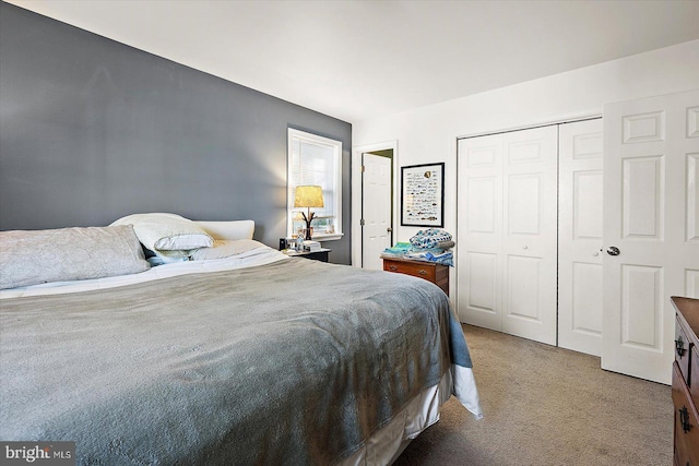 carpeted bedroom featuring a closet