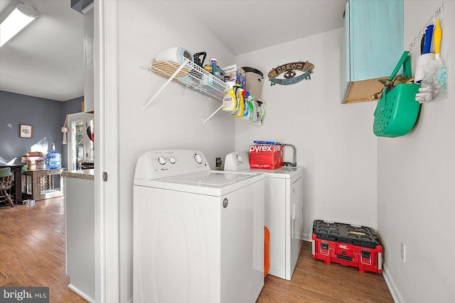 laundry area featuring hardwood / wood-style floors and washer and dryer