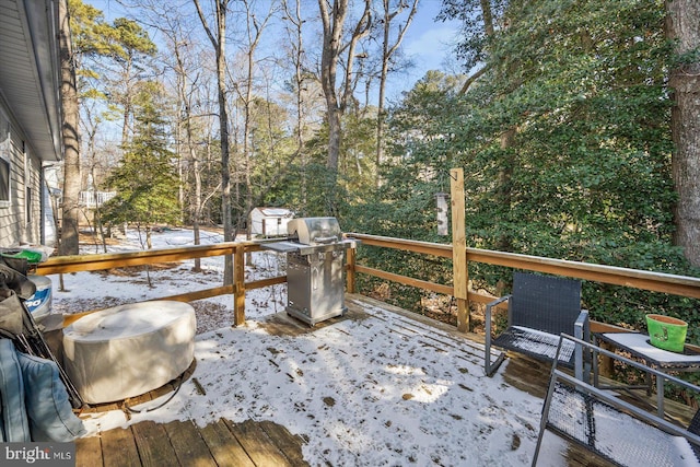 snow covered deck featuring grilling area