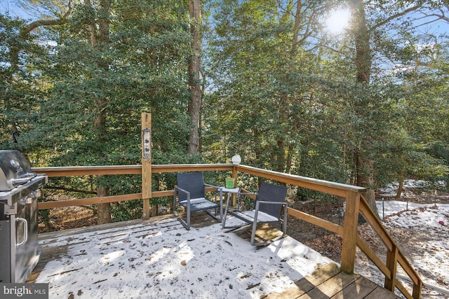 wooden terrace featuring a grill