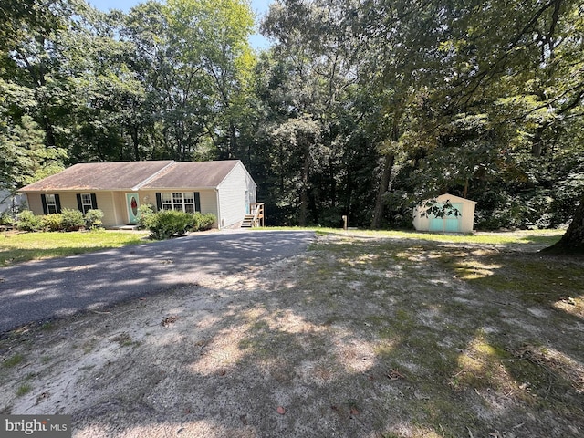 view of front of house with a storage unit