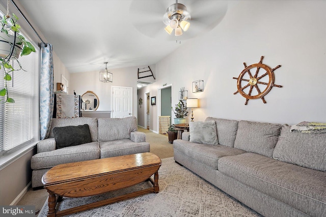 carpeted living room with vaulted ceiling and ceiling fan