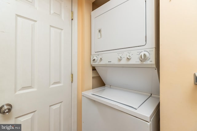 laundry area featuring stacked washer / dryer