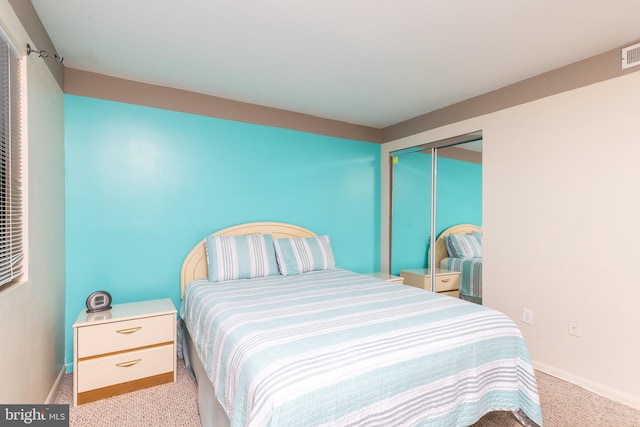 carpeted bedroom featuring a closet