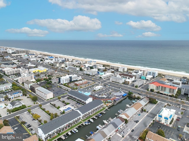 birds eye view of property with a view of the beach and a water view