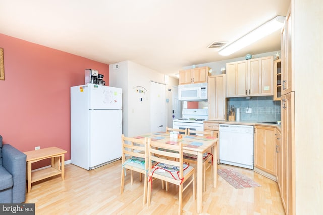 kitchen featuring light brown cabinets, white appliances, tasteful backsplash, and light hardwood / wood-style floors