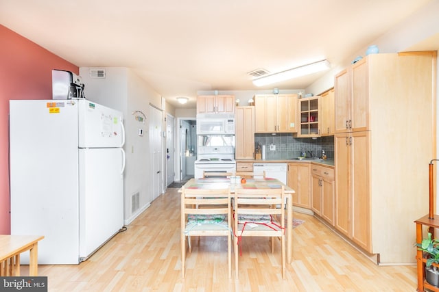 kitchen with white appliances, light hardwood / wood-style flooring, tasteful backsplash, light brown cabinets, and sink