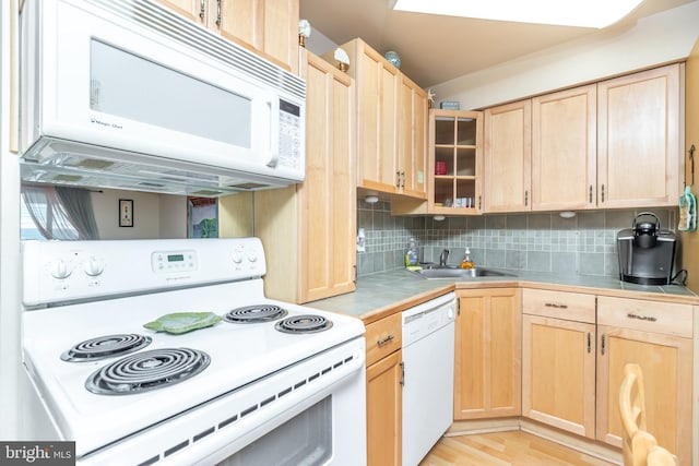 kitchen with sink, white appliances, light brown cabinetry, and backsplash