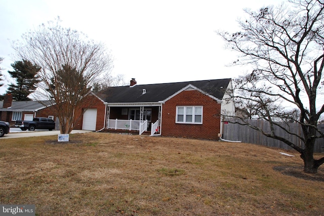 view of front of home with a garage, covered porch, and a front lawn