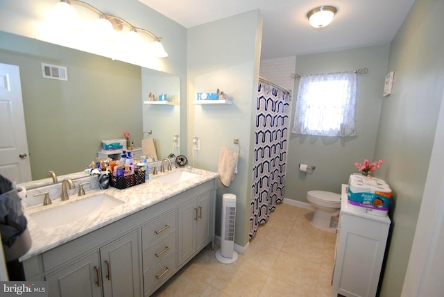 bathroom featuring toilet, vanity, tile patterned floors, and walk in shower