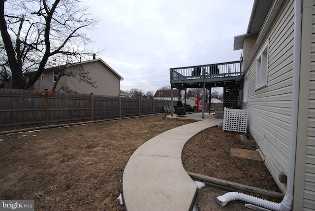 view of yard featuring a patio area and a deck