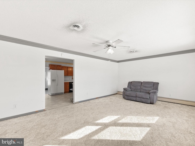 unfurnished room featuring baseboard heating, ceiling fan, light carpet, and ornamental molding