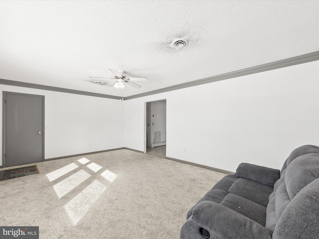 living room with a textured ceiling, light carpet, ceiling fan, and ornamental molding