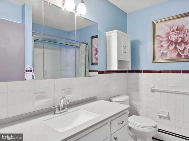 bathroom featuring curtained shower, tile walls, toilet, a baseboard heating unit, and vanity