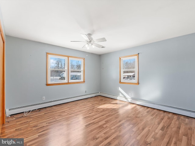 empty room featuring baseboard heating, light wood-type flooring, and ceiling fan