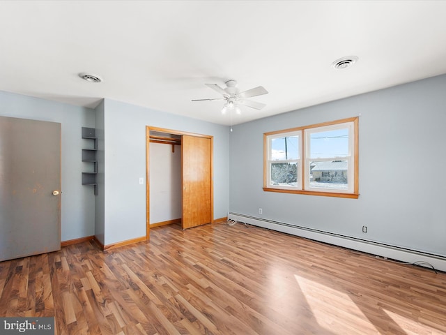 unfurnished bedroom with a baseboard radiator, a closet, ceiling fan, and light wood-type flooring