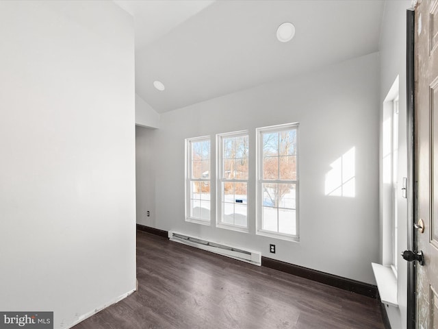 unfurnished room with dark wood-type flooring, vaulted ceiling, and a baseboard radiator