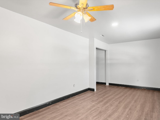 empty room with wood-type flooring and ceiling fan