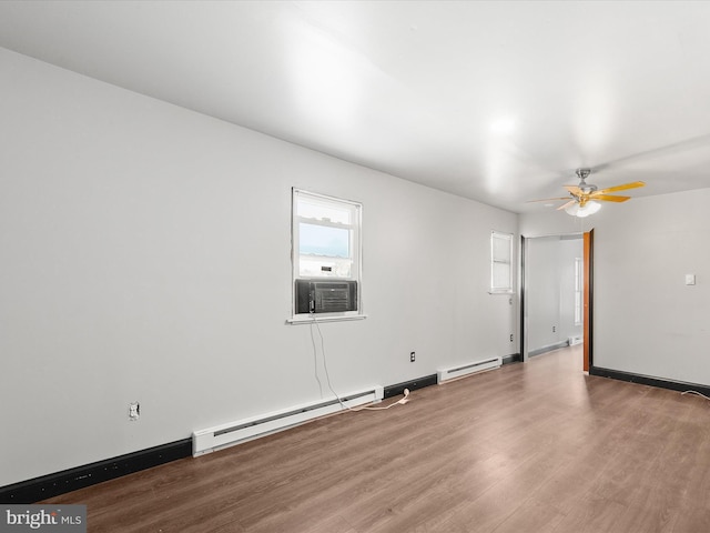 unfurnished room featuring cooling unit, hardwood / wood-style floors, a baseboard heating unit, and ceiling fan